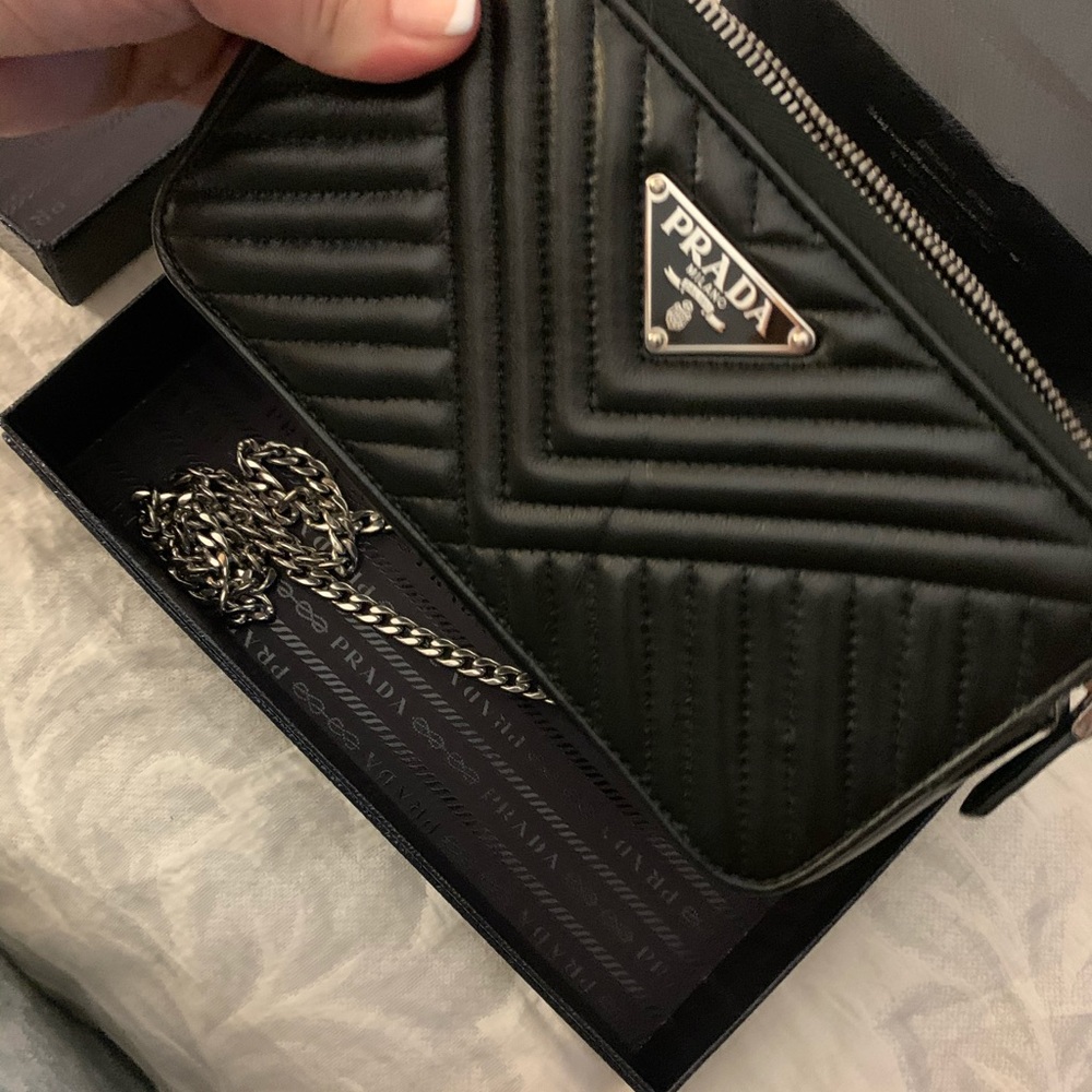 Dual pocket crossbody clutch with silver chain.